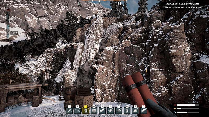 First-person gameplay scene exploring a snowy mining camp