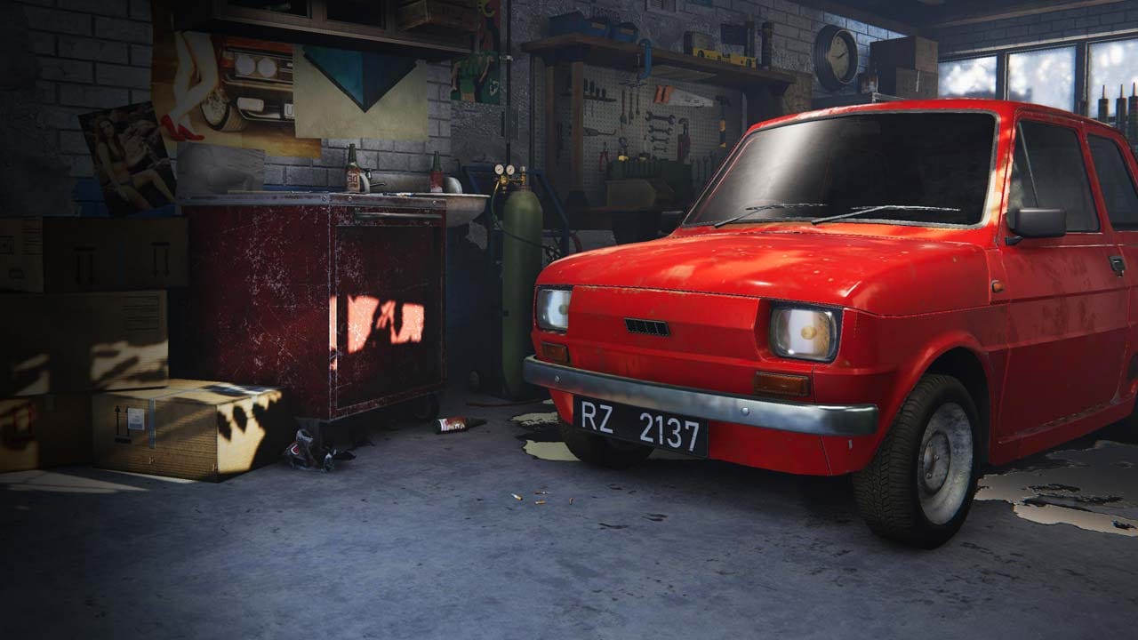 Rural workshop yard with old cars and small garage in a 1990s Polish village setting