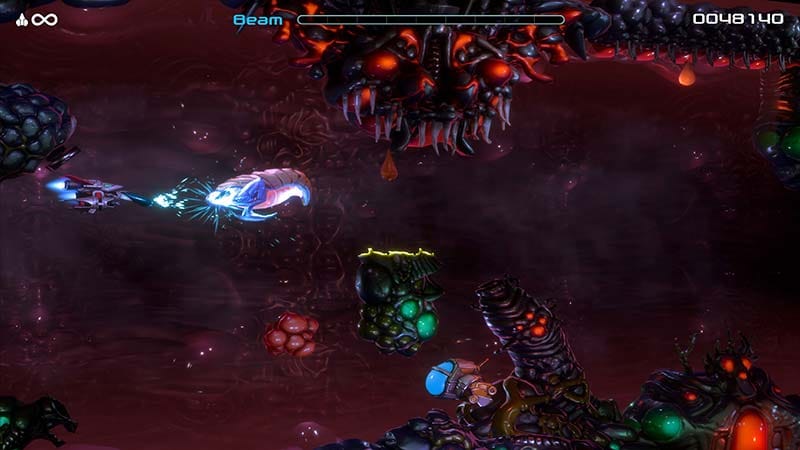 Boss encounter in a layered 2.5D environment featuring a large biomechanical organism