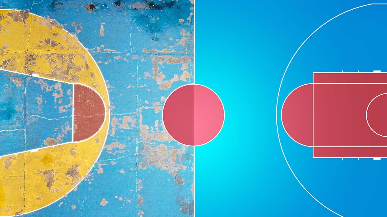 Interior of a worn sports facility with damaged flooring and renovation tools visible